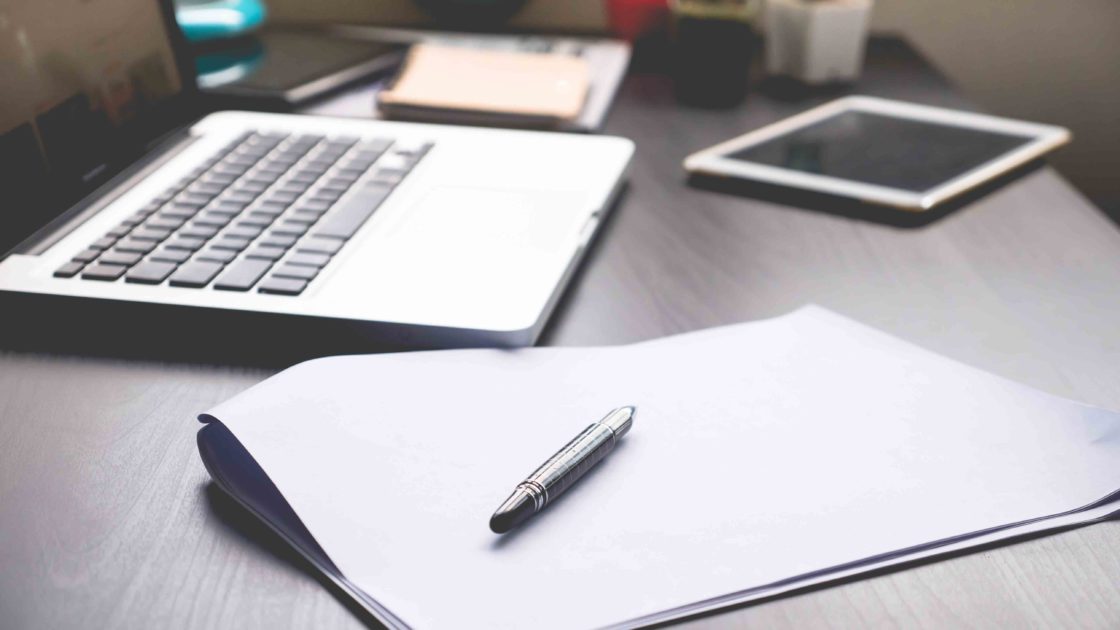 laptop, ipad & pen on a desk